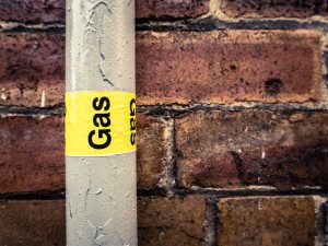 A gas pipe with the word " gas " written on it.