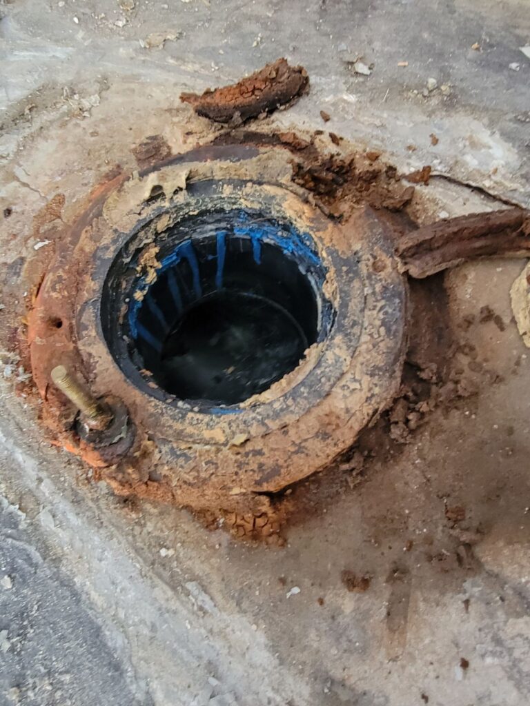 Corroded cast iron sewer cleanout opened for sewer repair